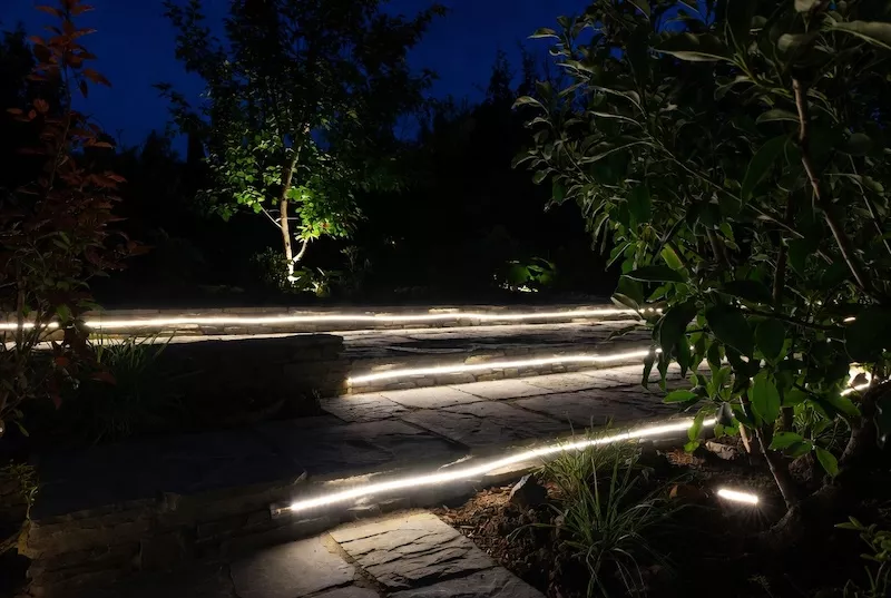Safely guide guests through gardens and pathways with subtle, low-voltage LED strip lights that blend seamlessly into the landscape for elegant nighttime accent lighting